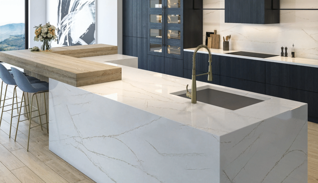 a white marble countertop with a gold faucet